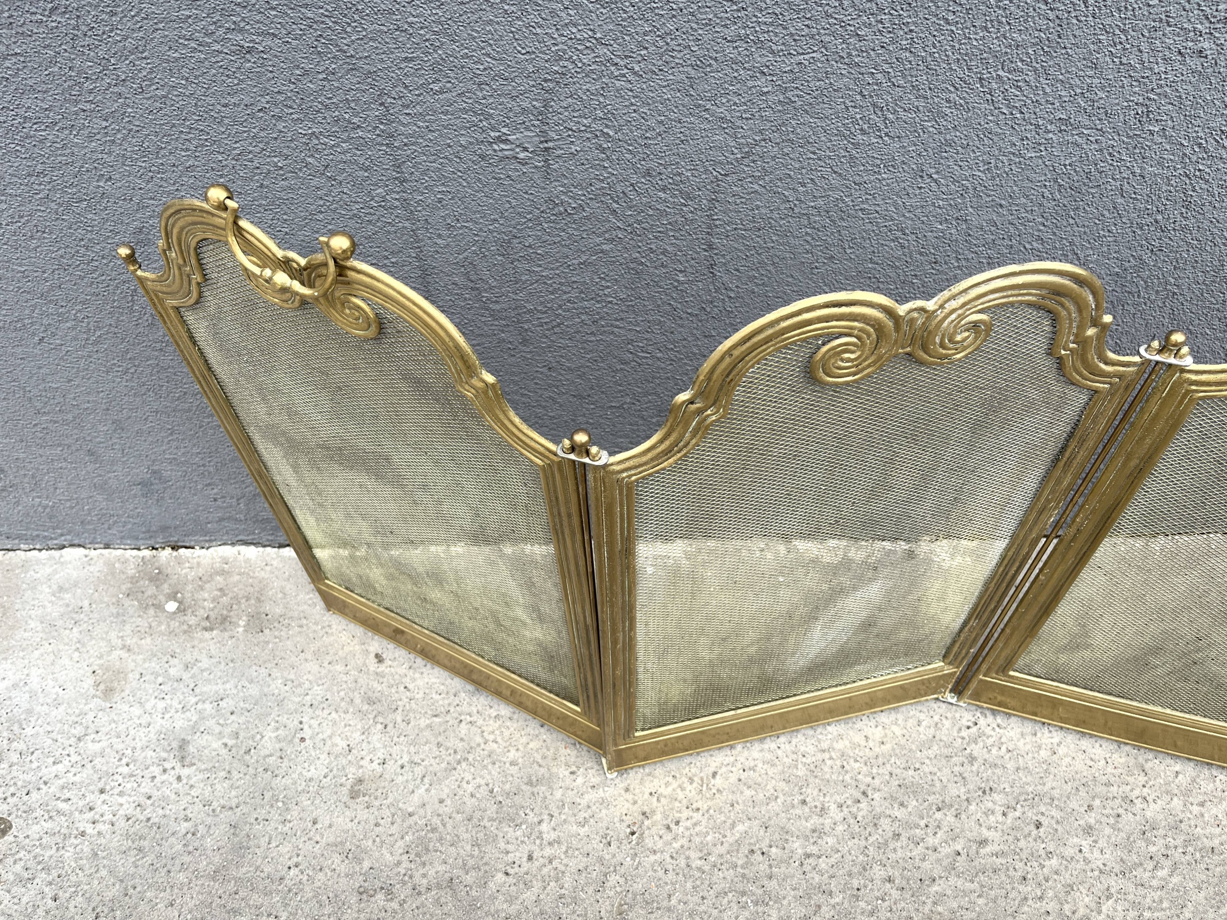 Antique brass fireplace screen from 1920, vintage spark guard.
