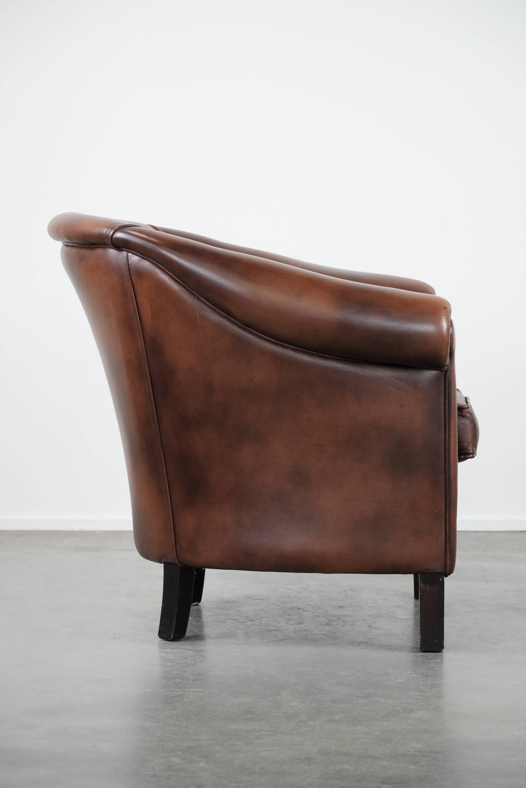Great luxurious brown cowhide club armchair with matching piping