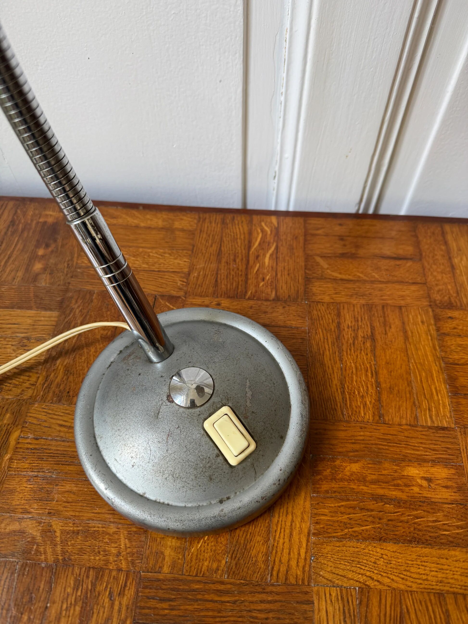 Industrial metal workshop lamp with a gooseneck.