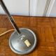 Industrial metal workshop lamp with a gooseneck.