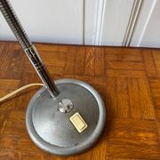 Industrial metal workshop lamp with a gooseneck.
