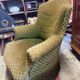 Green velvet toad armchair with wheels and fringes