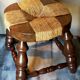 Low vintage regional stool in solid wood with straw top