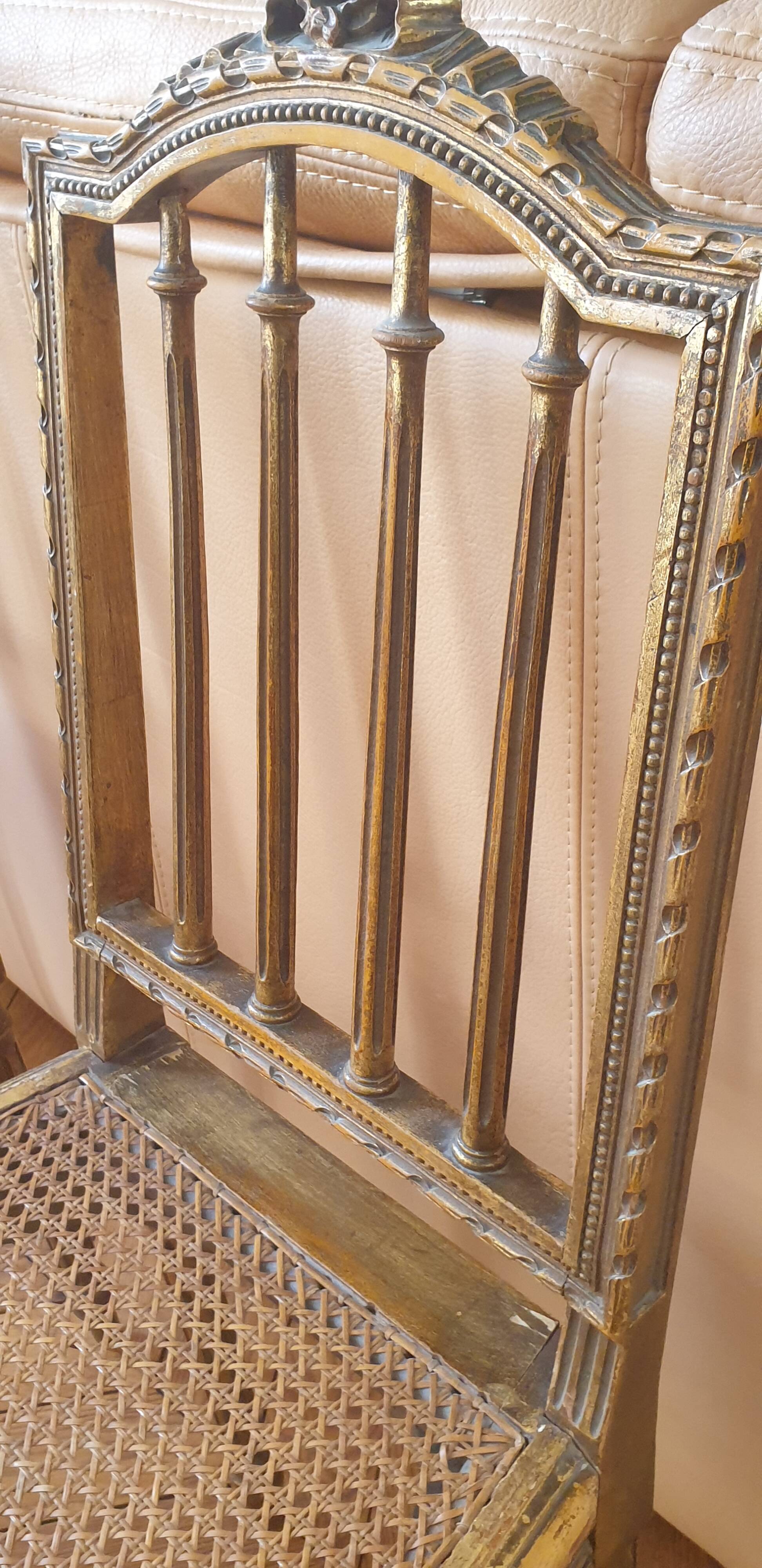 Pair of Louis XVI caned chairs with carved gilded wood.