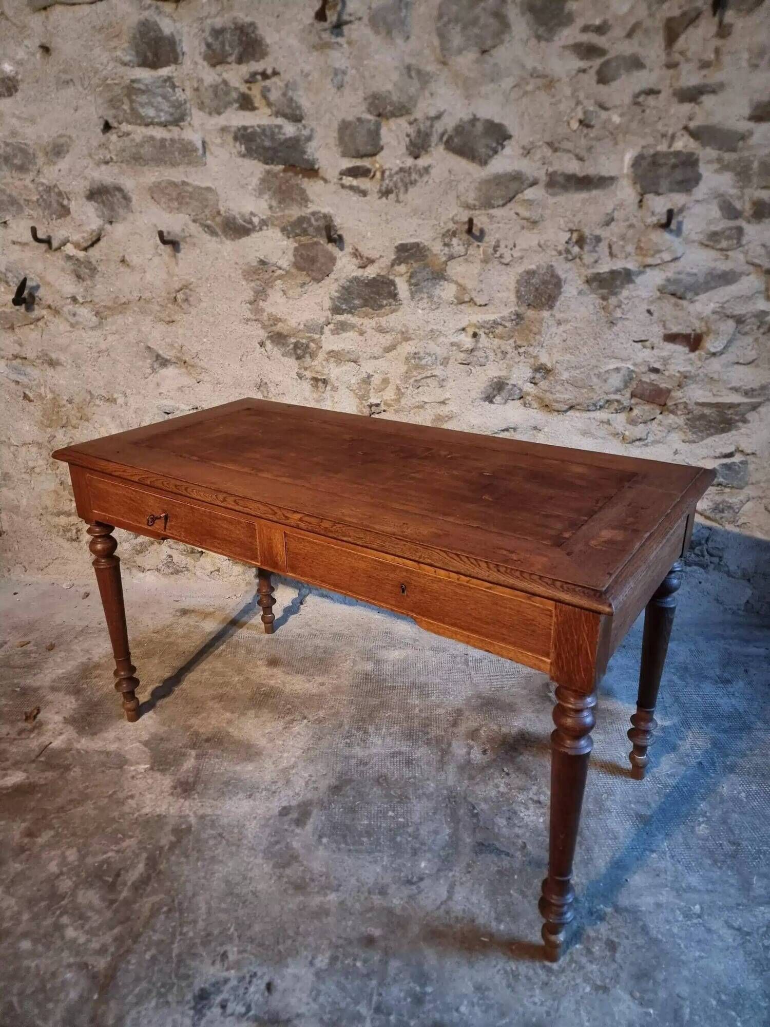 Antique French writing desk in oak with two drawers, 1920s.