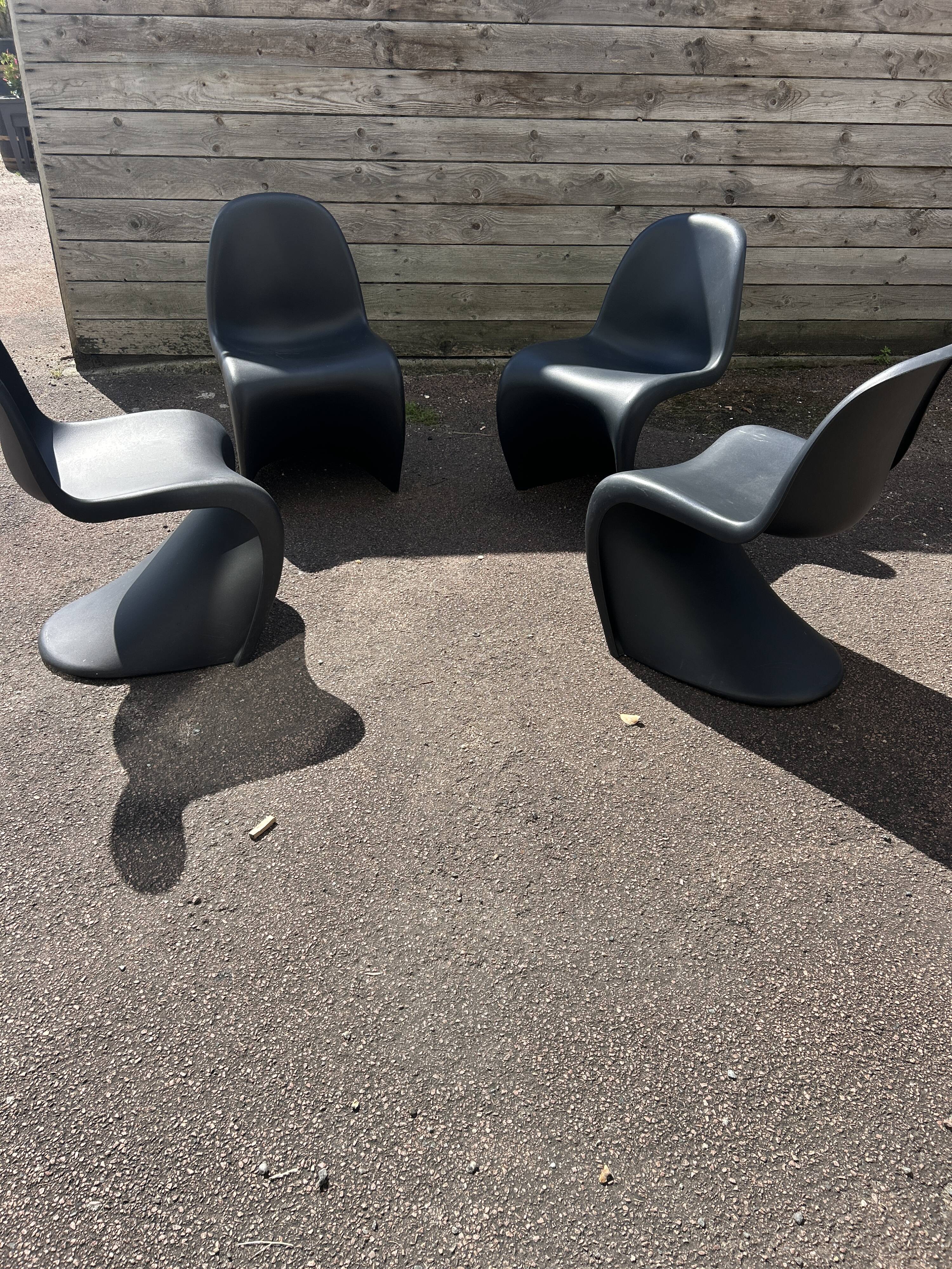 Set of 4 black Verner Panton Vitra chairs.