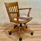 Solid wood swivel and reclining armchair.