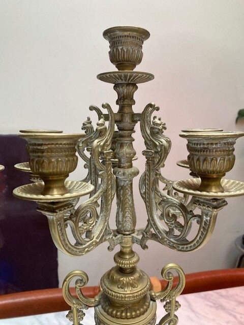 Fireplace trim clock and adornment of antique bronze candelabra