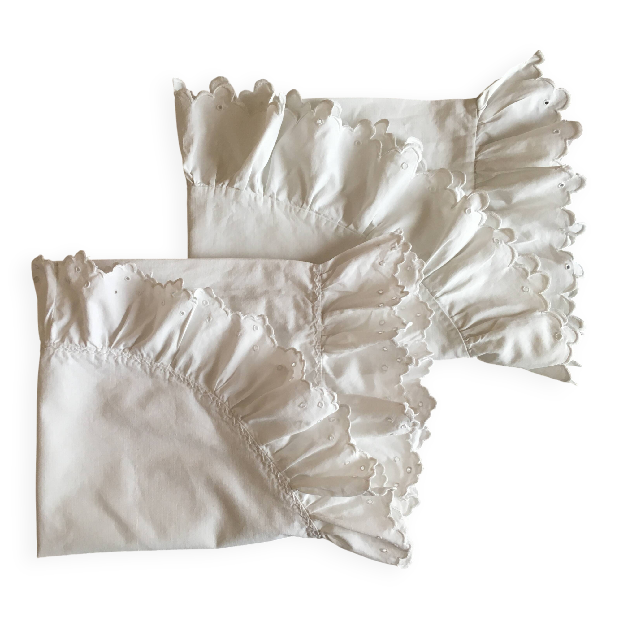 Two half-moon ruffled cushion covers
