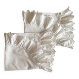 Two half-moon ruffled cushion covers