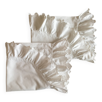 Two half-moon ruffled cushion covers