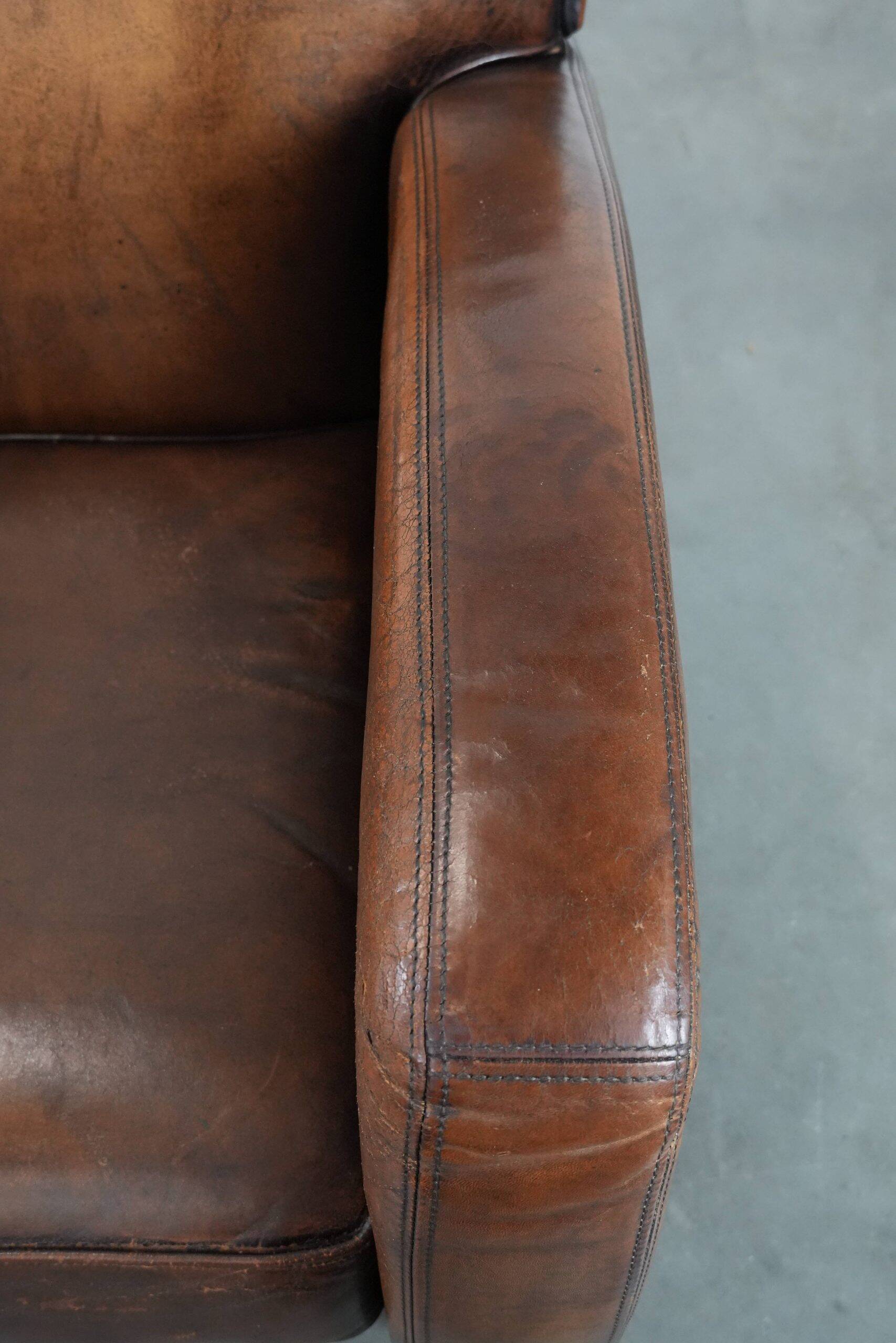 Characterful vintage sheepskin leather armchair with beautiful colours