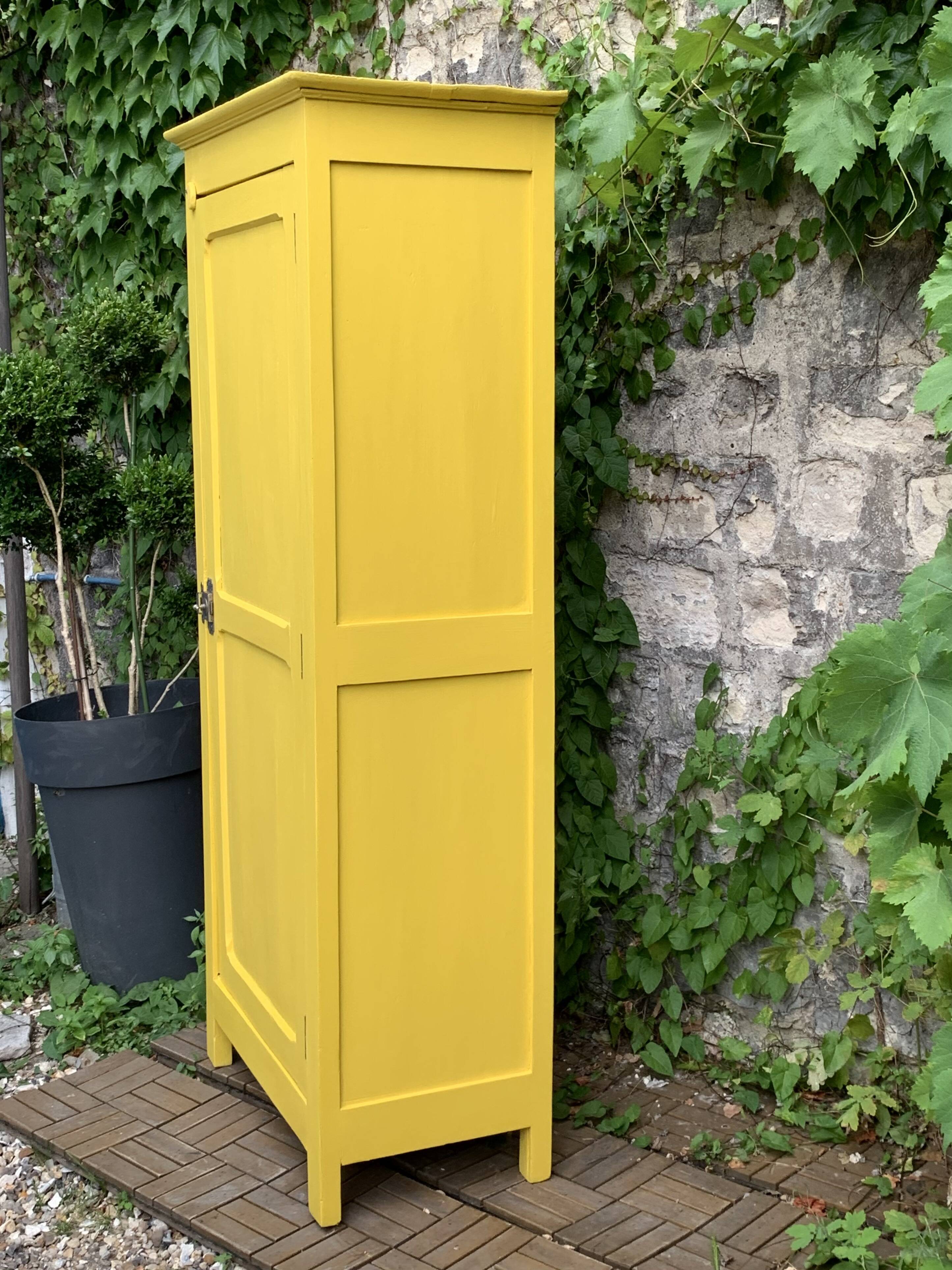 Antique powder yellow Parisian bonnetière wardrobe.