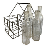 4 graduated bottles in their bottle holder