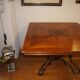 Square cherry wood table with drop leaves.