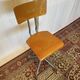 Old high workshop chair made of wood and metal.