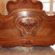 Walnut rocaille bed from the early 20th century.