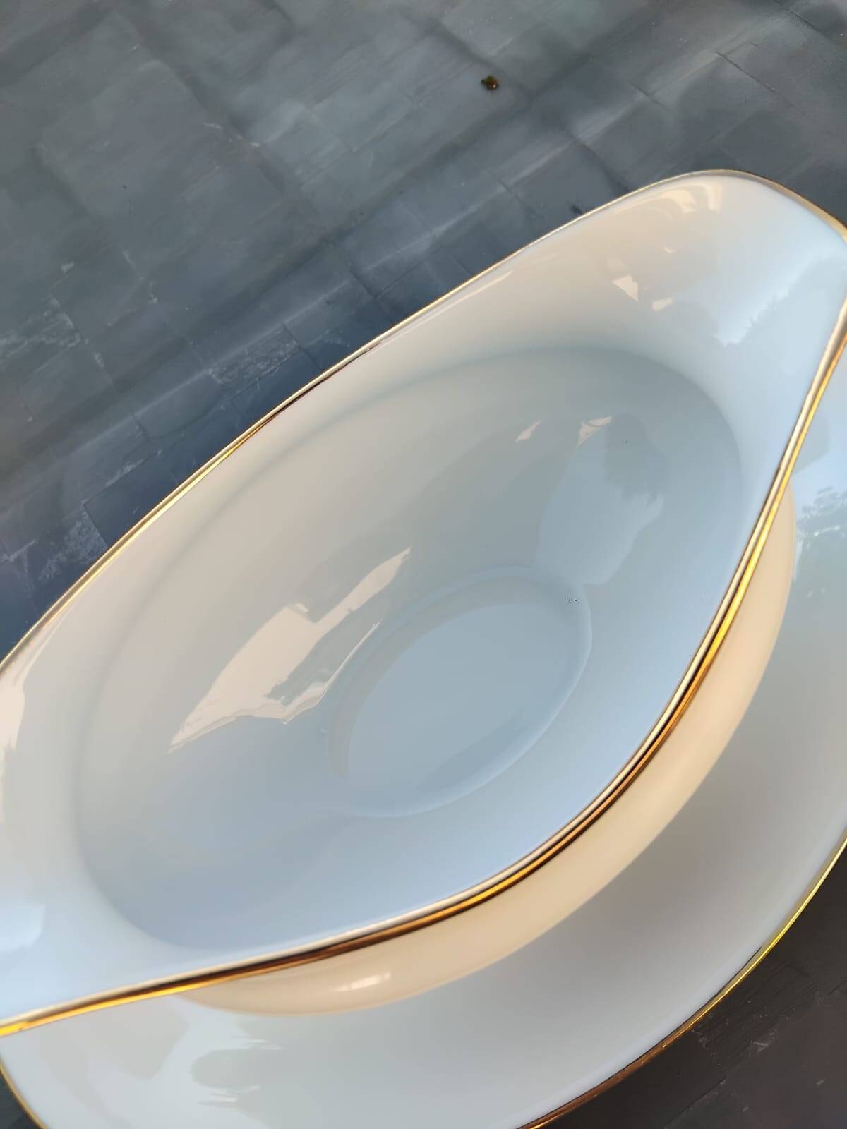 Vintage fine porcelain sauce boat with gold gilding.