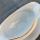 Vintage fine porcelain sauce boat with gold gilding.