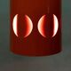 Vintage orange suspension light in a 1970s space age style.
