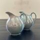 Pair of iridescent blue pitchers