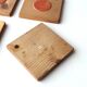 Six coasters in wood and orange ceramic, 70s