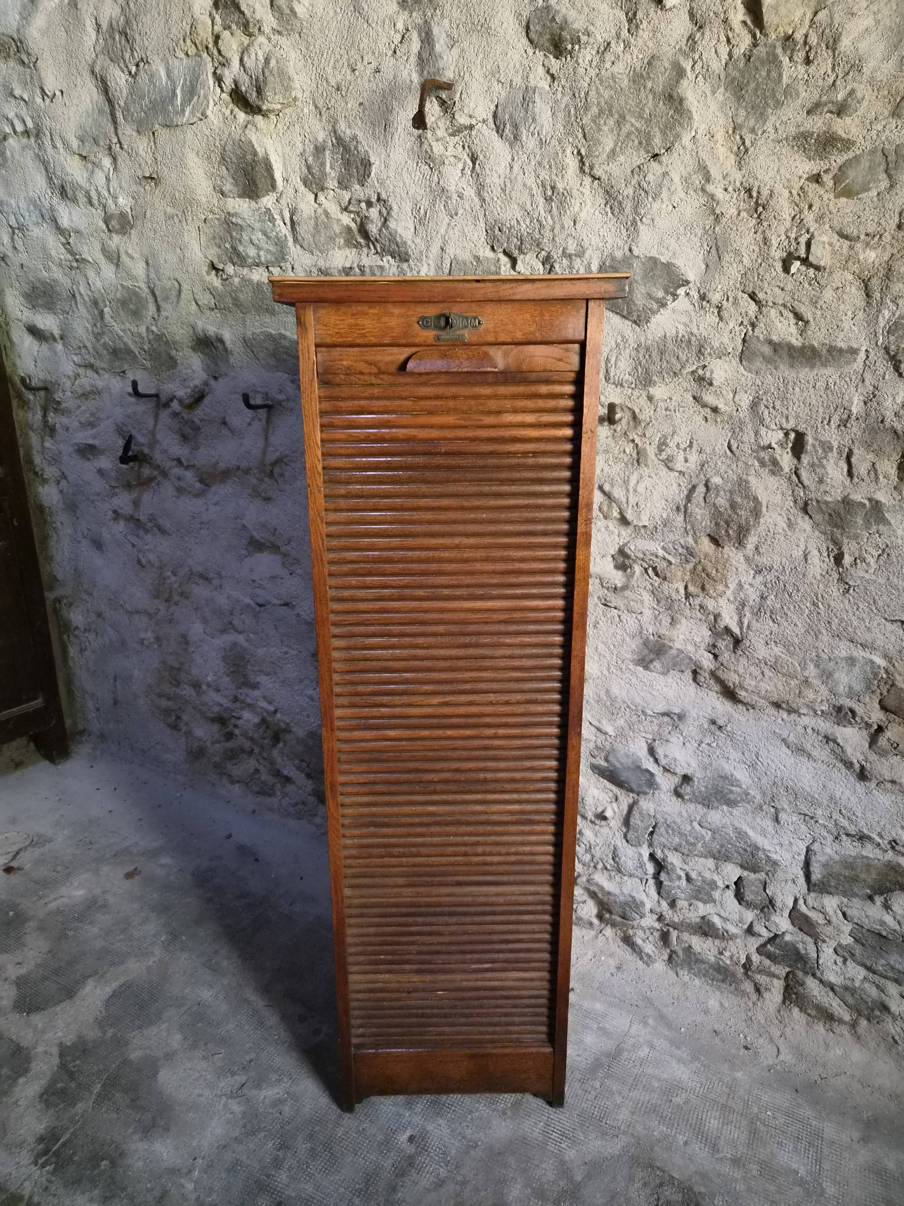 French antique wardrobe with curtain in oak, circa 1920–1930.