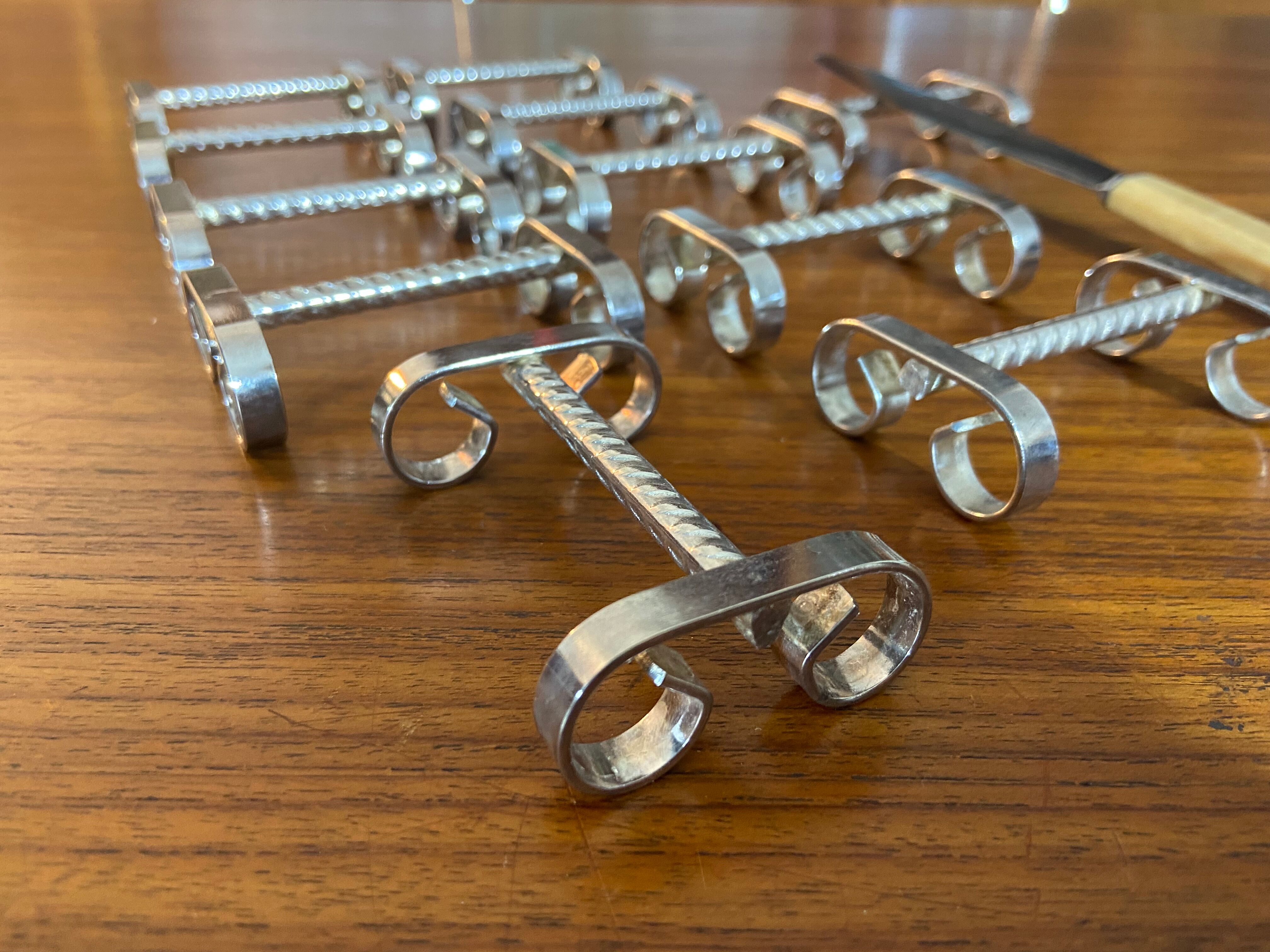 Set of 11 silver-plated metal knife holders, 1960