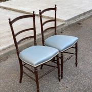 2 Napoleon III chairs in solid wood and blue satin fabric.