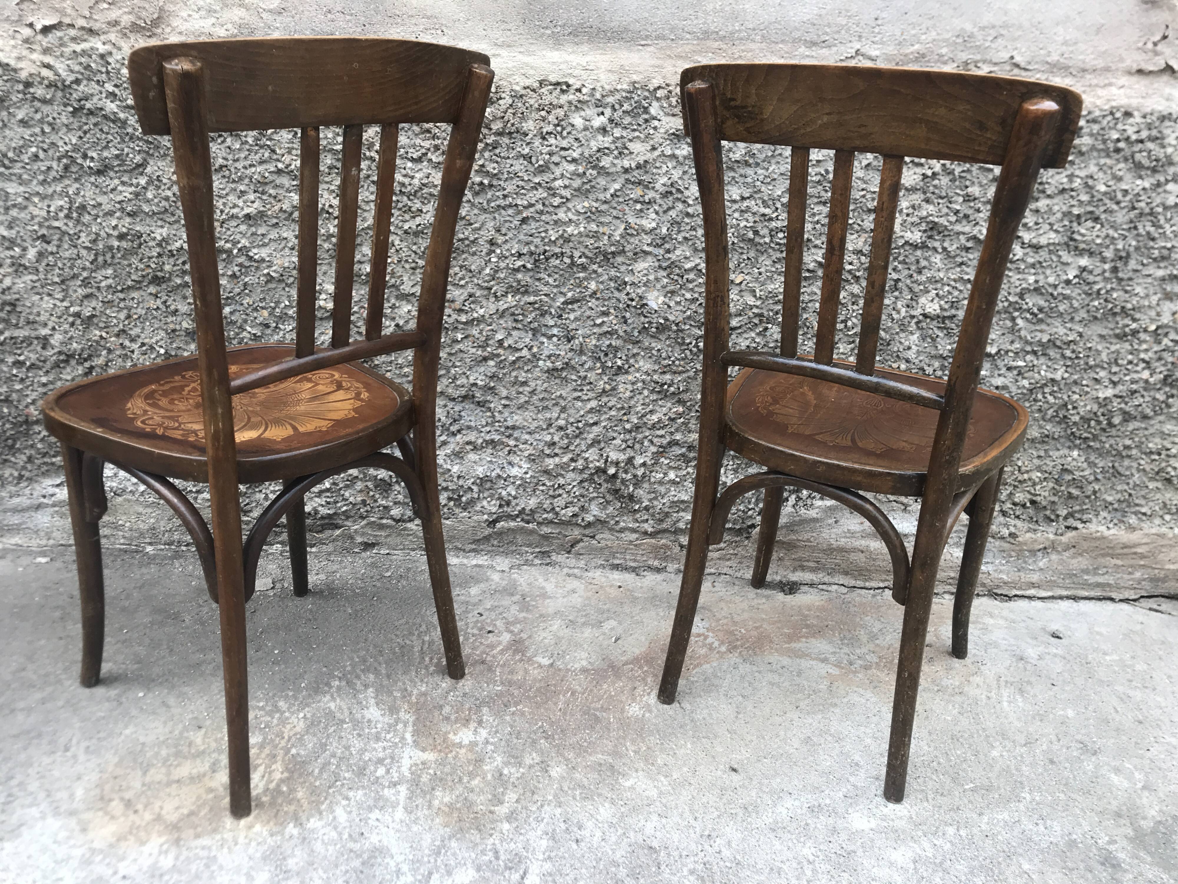 Pair of brasserie bistro chairs with seashell on seat