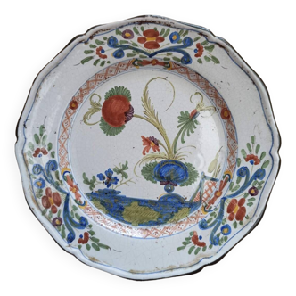 Eastern earthenware plate decorated with a ripe poppy flower