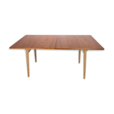 Dining table in teak and oak with extensions designed by Hans J. Wegner