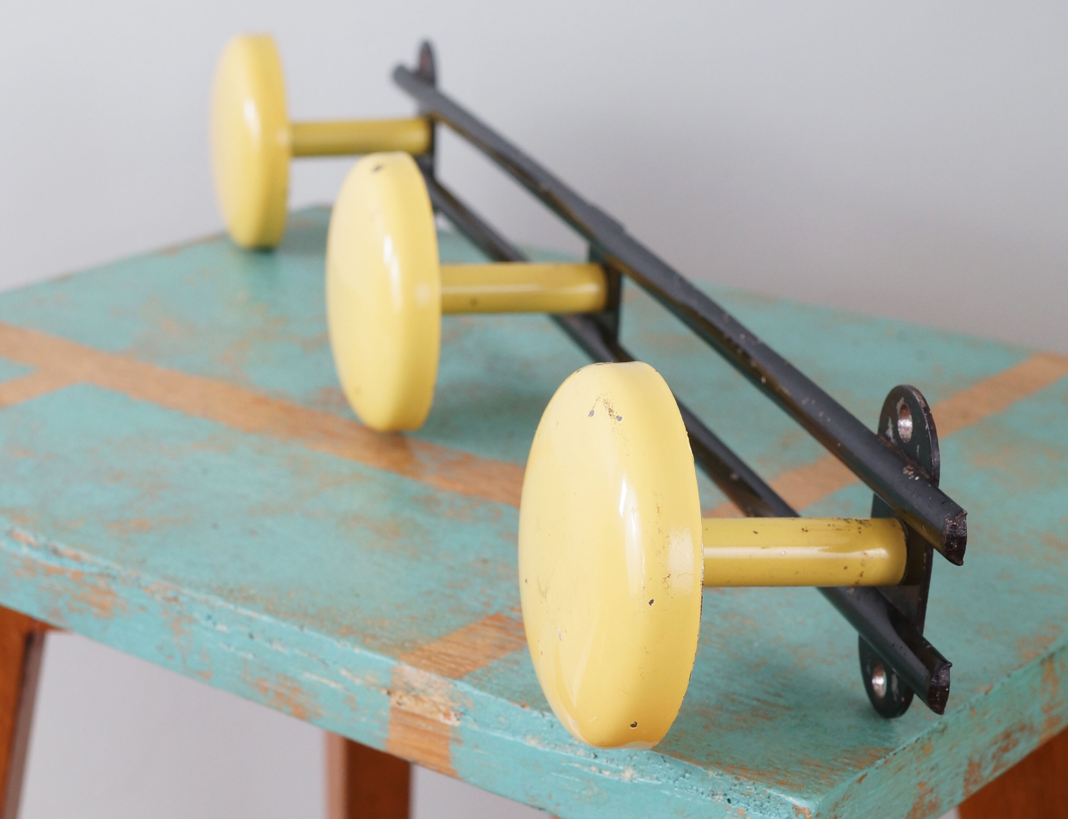 Yellow and black enamelled metal hook, 60s