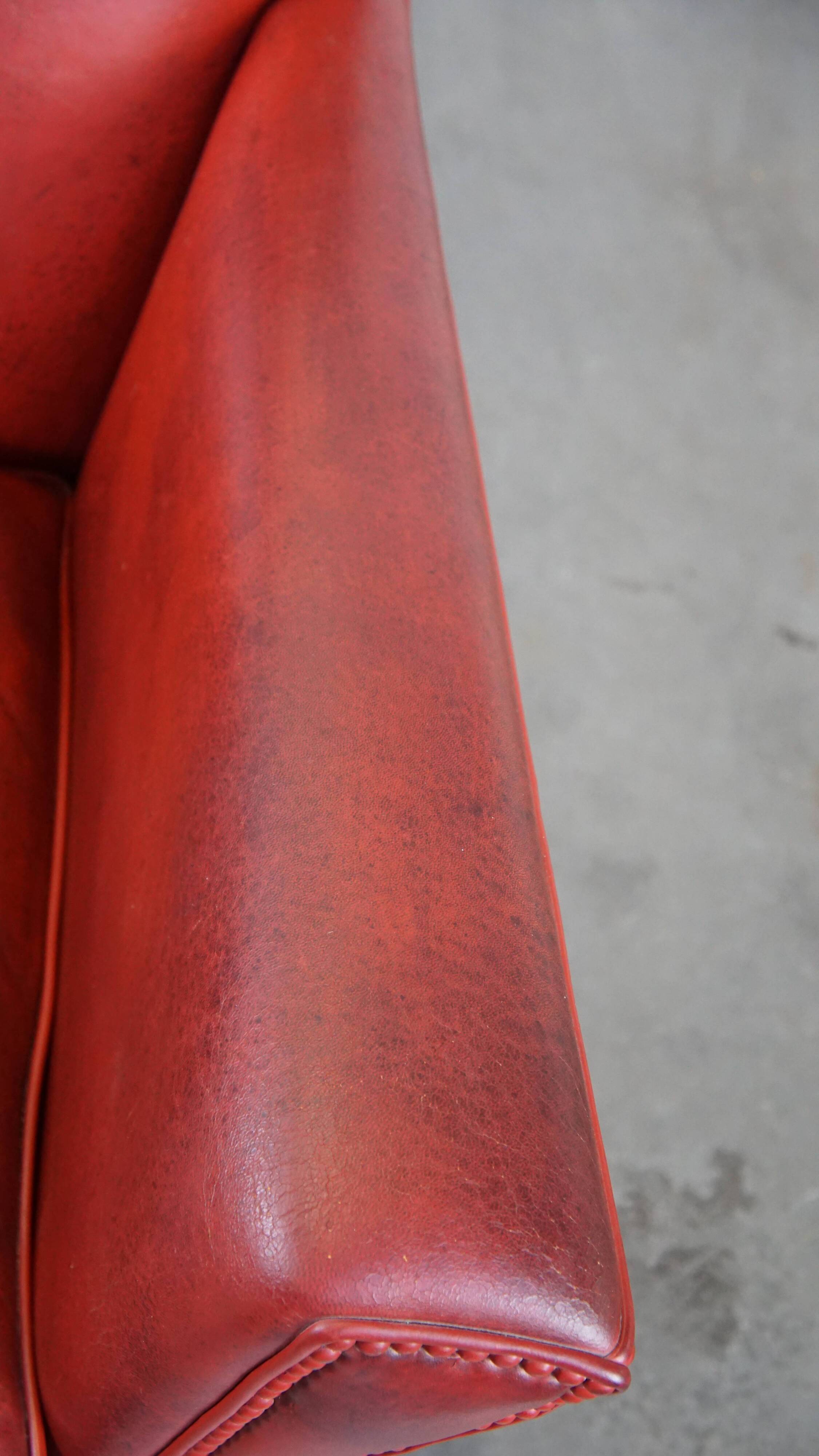 Red-painted armchair made of sheepskin leather
