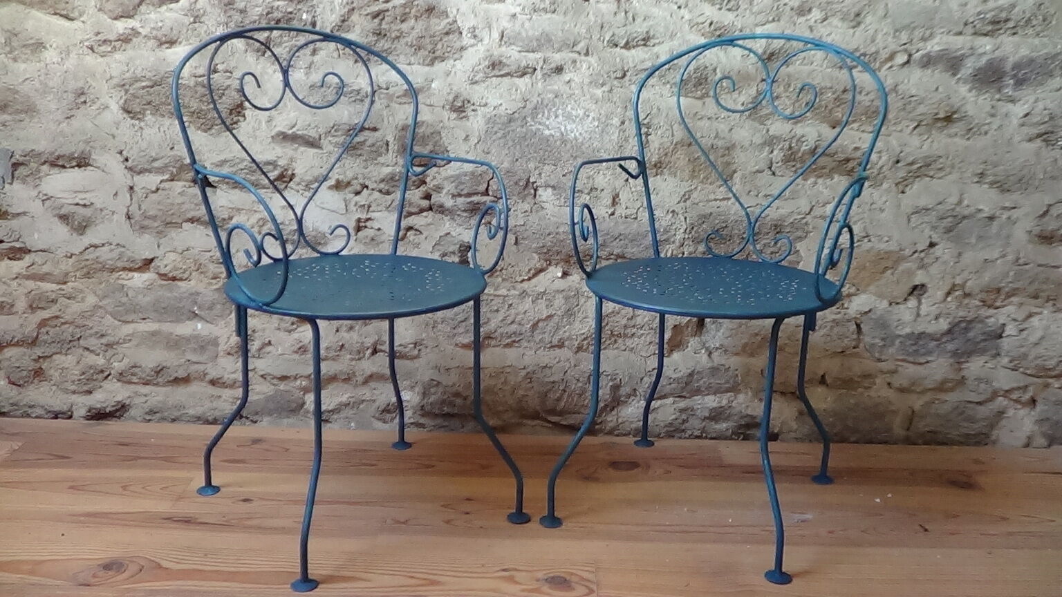 A pair of metal garden chairs
