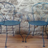 A pair of metal garden chairs