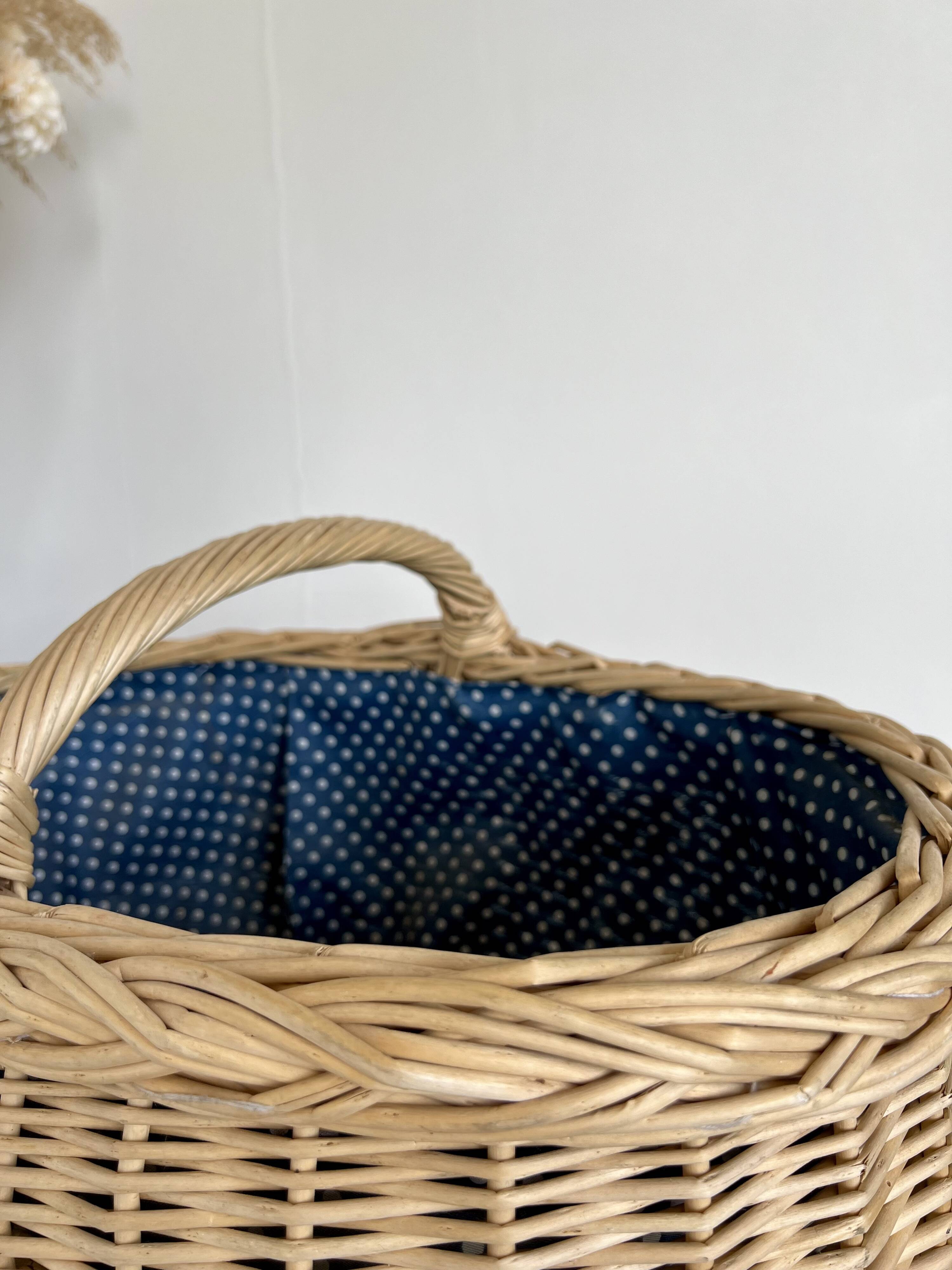 Large vintage wicker basket and blue lining with white polka dots