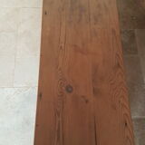 Church bench in fir tree with armrests