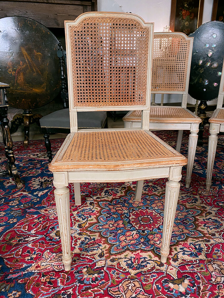 Set of four grey lacquered wooden chairs in the Louis XVI style, late 19th century.