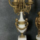 Pendule triptyque aux "Amours de Bacchus" en bronze a patine brune.