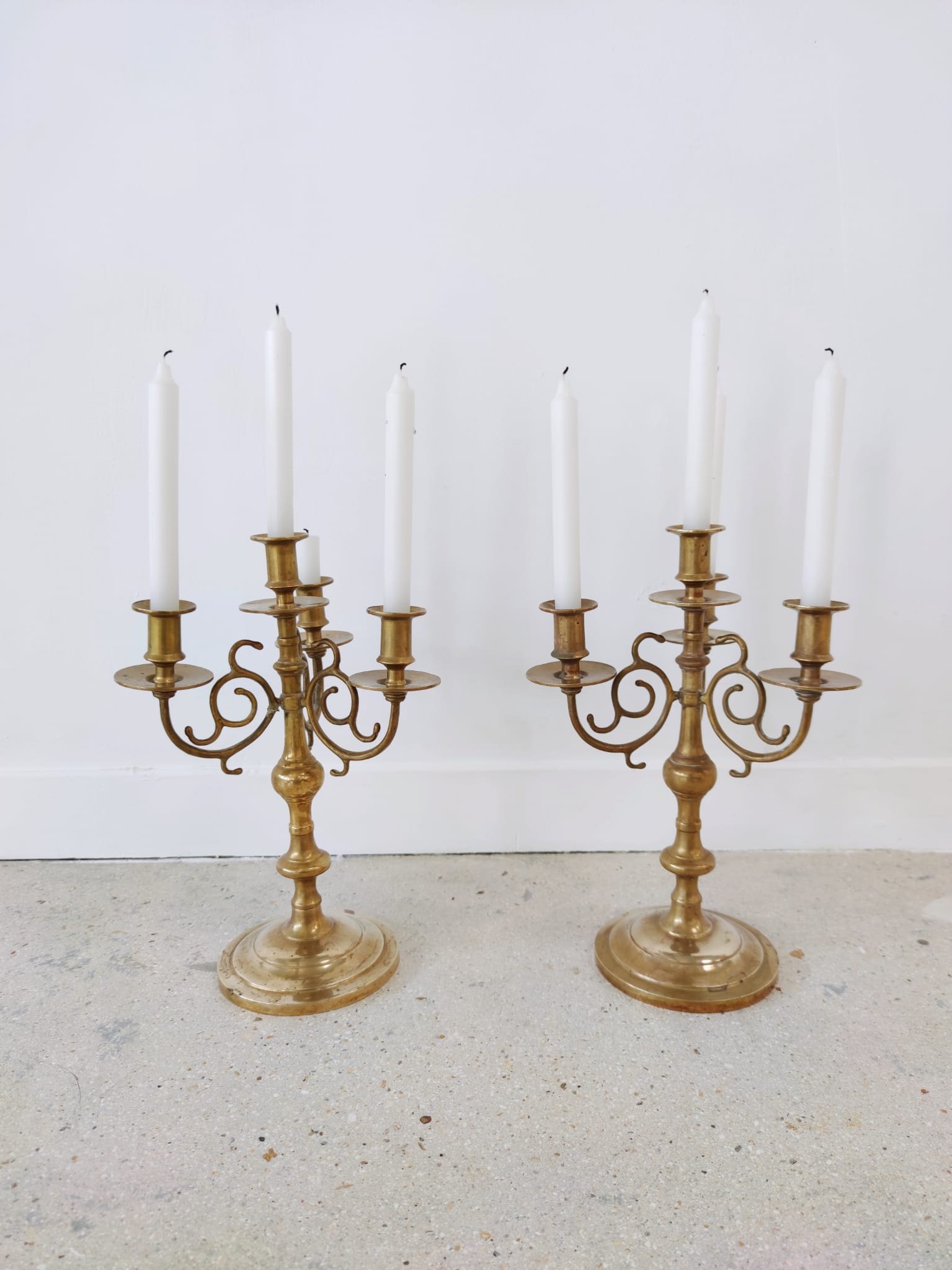 Pair of four-light candle holders in gilded brass