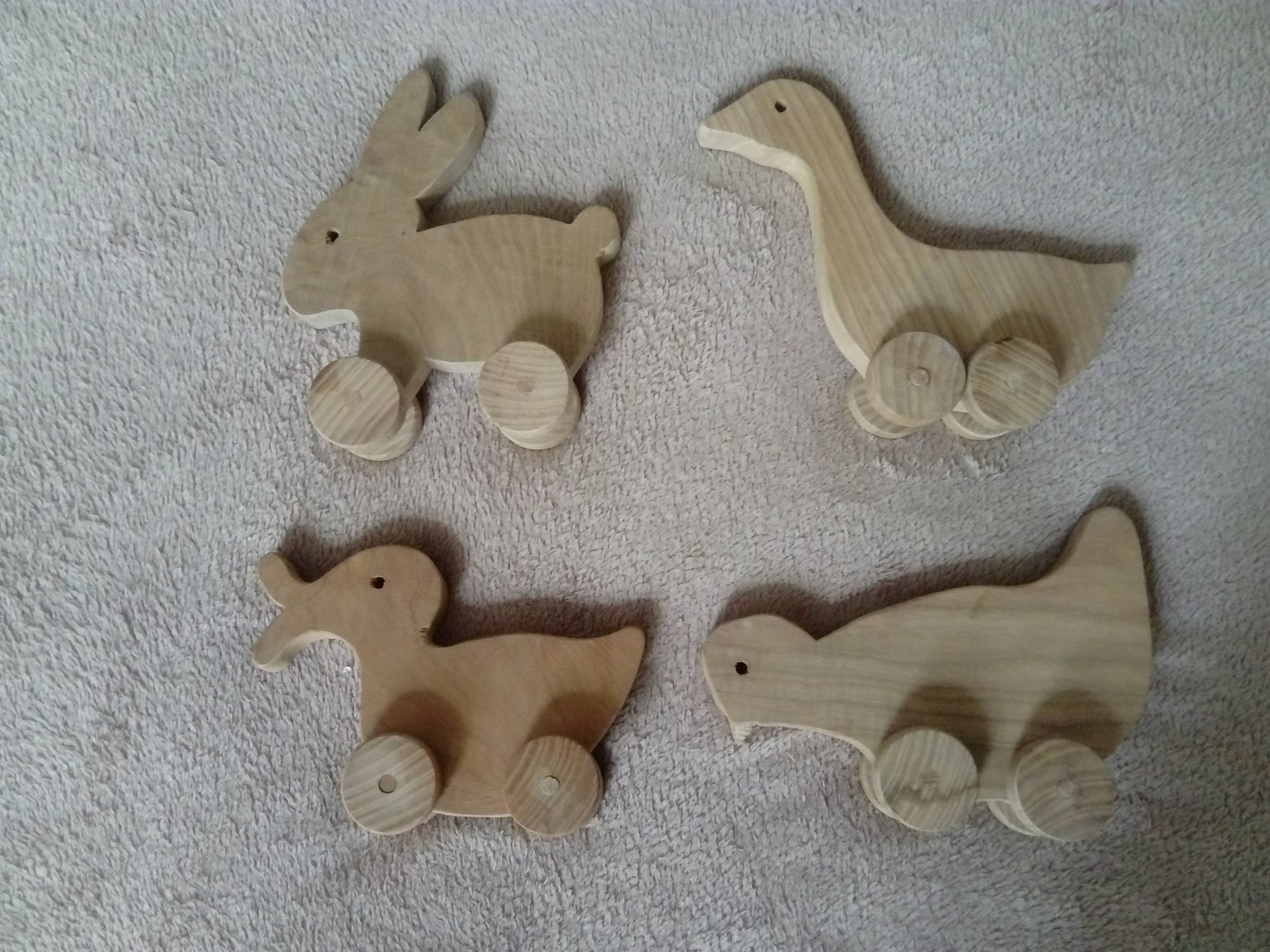 set of 4 wooden toys on wheels