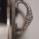 Silver-plated service tray with handles, neoclassical decoration.