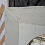 Oval mirror with a distressed white frame