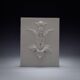 Bas-relief plaster mural with a fleur-de-lis design.