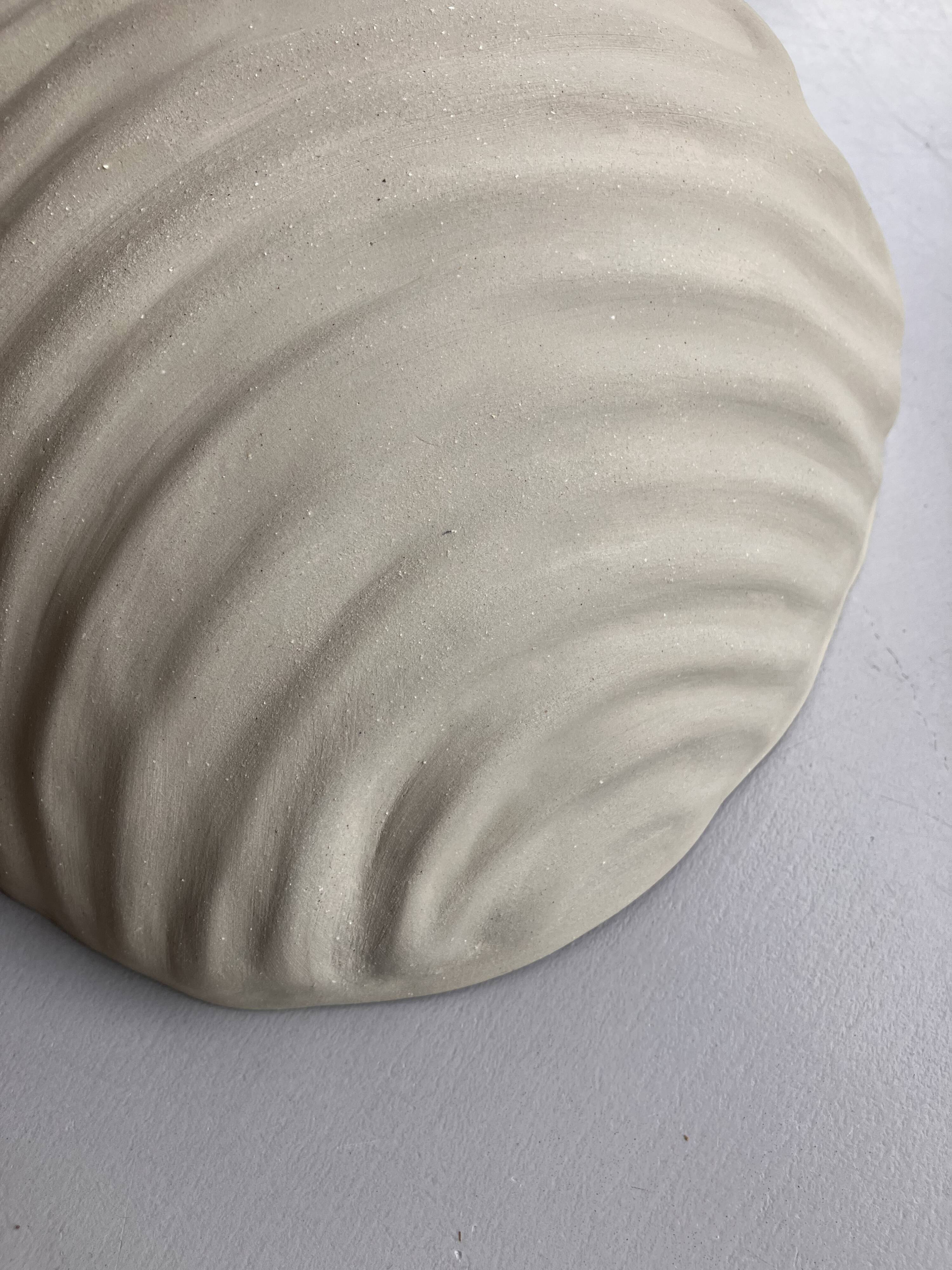 Shell-shaped ceramic applique handcrafted.