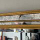 Deknudt mirror in gilded wood and with beading.