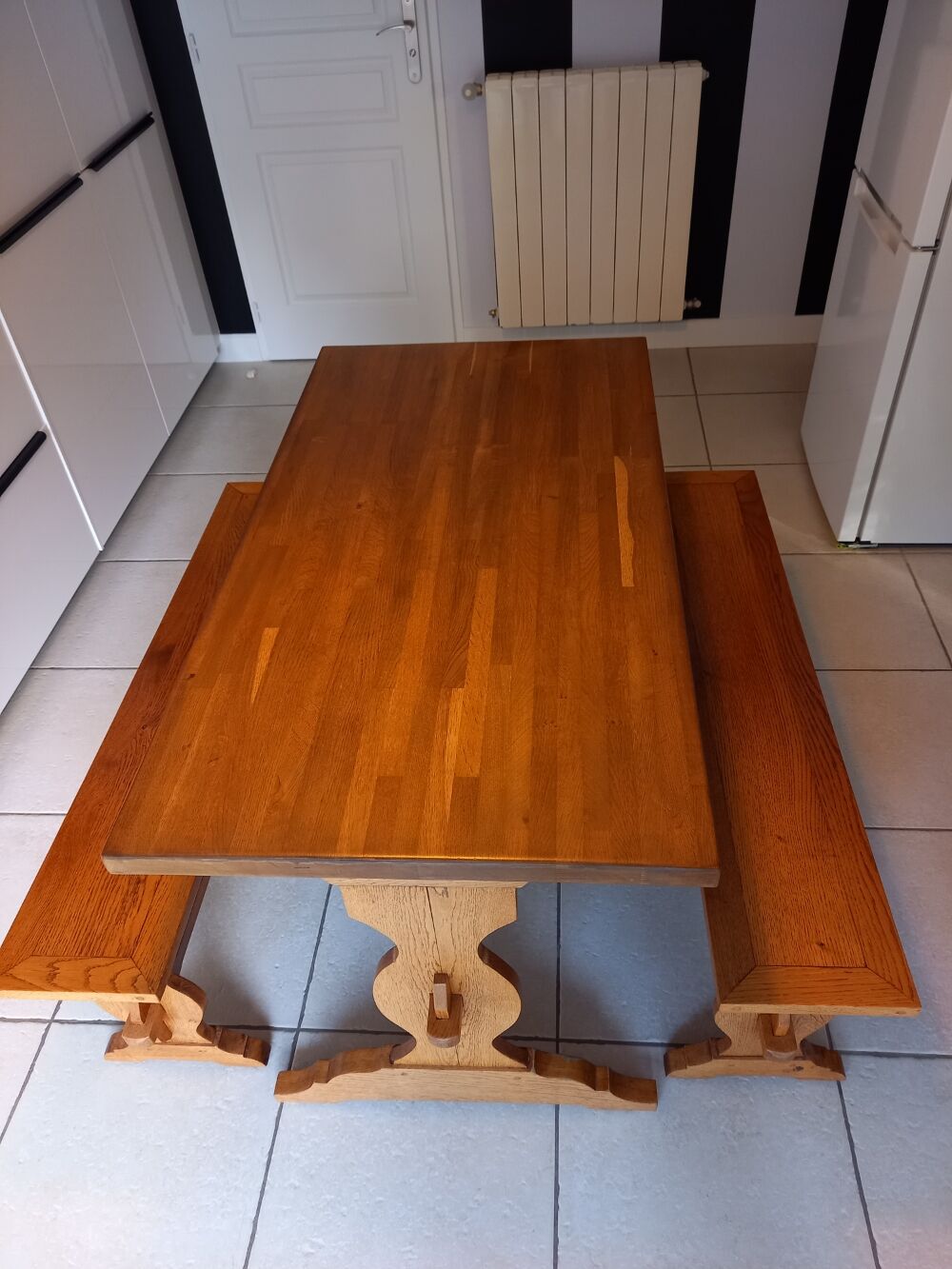 Solid oak table and its two benches made by a craftsman.