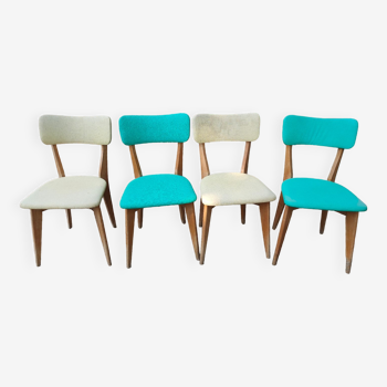 Set of 4 vintage chairs in wood and imitation blue leather dating from the 50s. Wooden structure. Seat and backrest in imitation leather 2 mint green and 2 yellow. Seating dimension: 46 cm. Good state of conservation, some traces of wear.