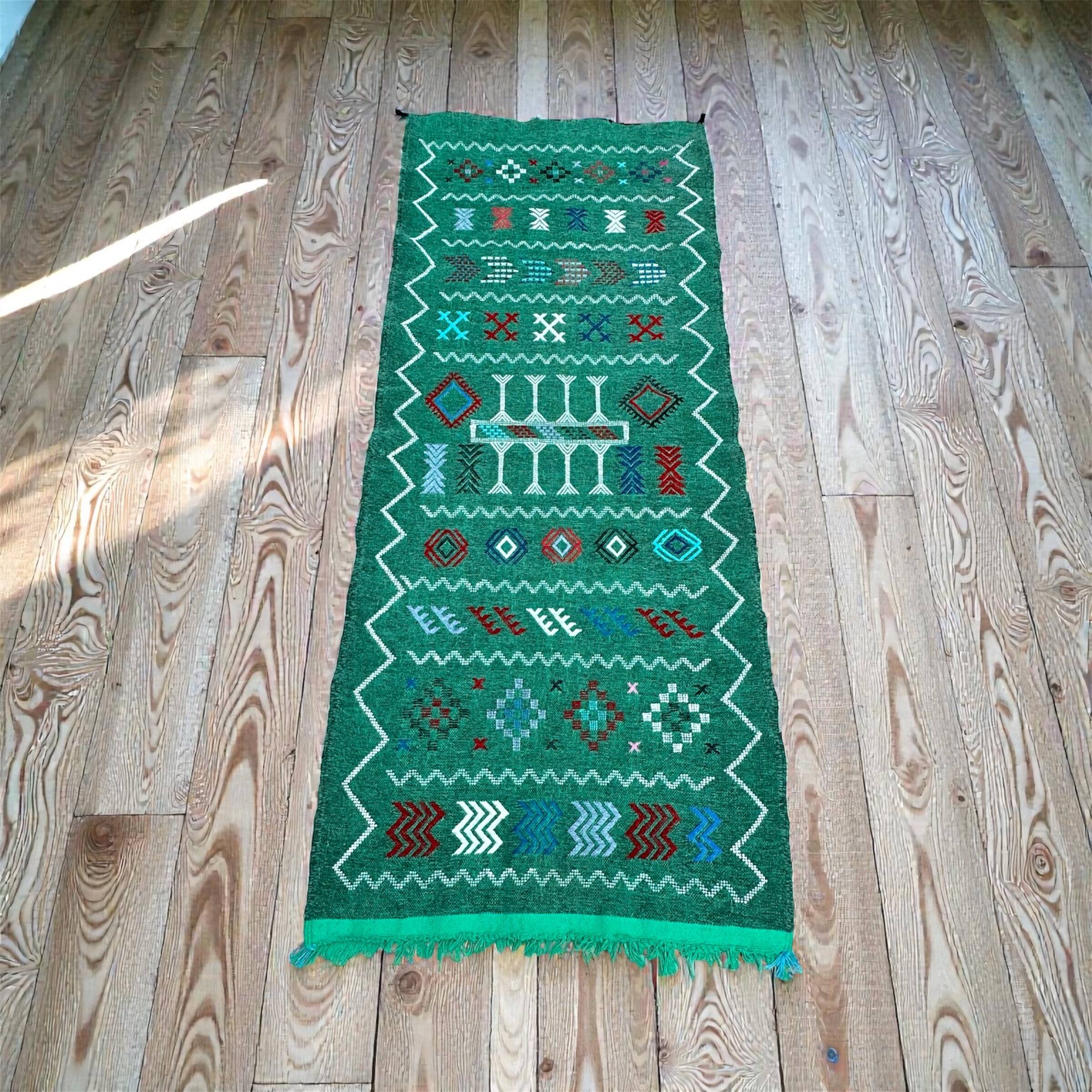 Handwoven green Moroccan hallway rug with geometric patterns.